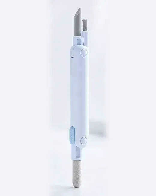 Rozłożone pióro-multitool Pucuśka: korpus z suwakiem, matowa silikonowa końcówka i mini-pędzelek